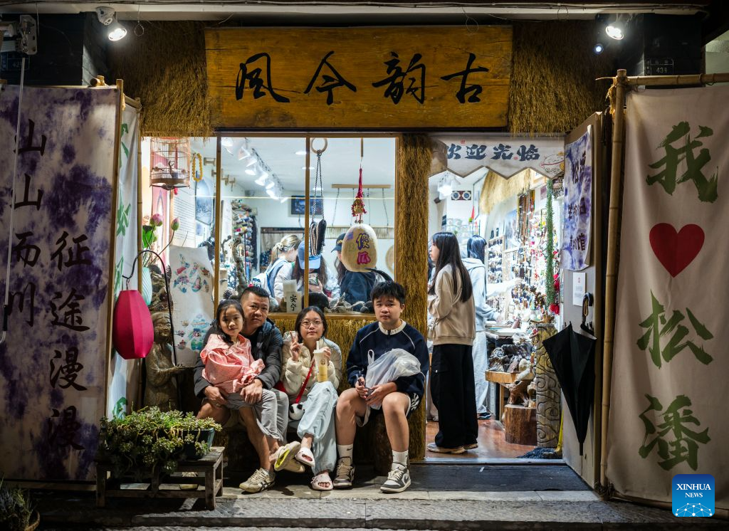 Tourists rest at Songzhou Ancient City in Songpan County of Aba Tibetan and Qiang Autonomous Prefecture, southwest China's Sichuan Province, Aug. 23, 2026. Songzhou Ancient City in Songpan County is now a major historical and cultural site protected at the national level. (Photo by Lan Hongguang/Xinhua)