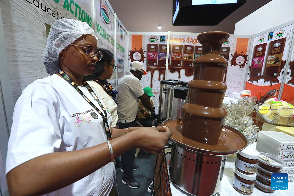 A staff member is seen in front of a chocolate fountain at an exhibition booth of the 10th National Cocoa and Chocolate Days in Abidjan, Cote d'Ivoire, on Sept. 1, 2026.
The event kicked off here on Tuesday. Under the theme Youth and the Cocoa Farming of the Future, the three-day event features a wide range of cocoa and chocolate products, and provides a platform for discussions on youth participation, local cocoa processing, technological innovation and the sustainable development of the sector. It brings together people from various segments of the cocoa industry, including cocoa farming, processing, exports and chocolate production to participate.
Cocoa is one of Cote d'Ivoire's most important cash crops and a key pillar of its agricultural and export economy. (Photo by Yvan Sonh/Xinhua)
