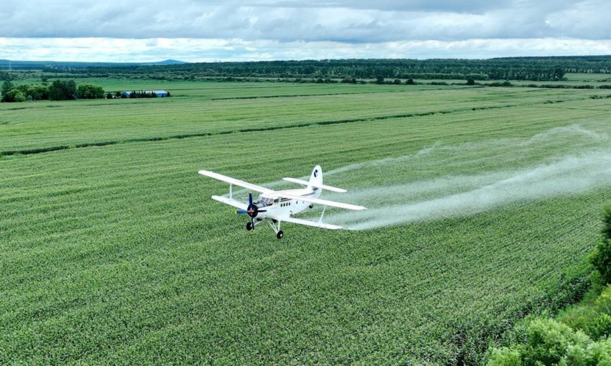 An aerial drone photo taken on July 29, 2026 shows an agricultural plane carrying out aerial crop protection operations over a farmland of Beidahuang Group in northeast China's Heilongjiang Province. (Photo by Li Ang/Xinhua)
