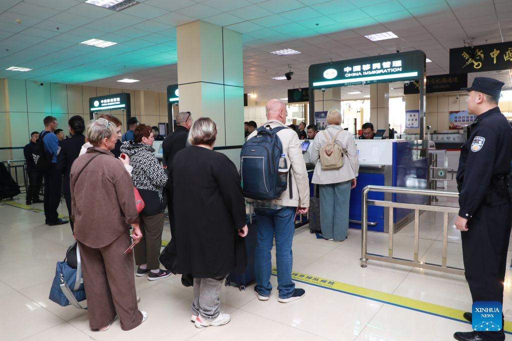 Police officers of Heihe border inspection station perform entry inspection for inbound foreign passengers at a port in Heihe, northeast China's Heilongjiang Province, Sept. 14, 2026. Cross-border personnel exchanges at the Heihe Port are getting more and more active since the implementation of the visa-free policy between China and Russia. The number of inbound and outbound passenger trips through the port since the beginning of 2026 has hit a record high of 1 million until Monday, an increase of 56.18 percent year on year. (Photo by Liu Song/Xinhua)