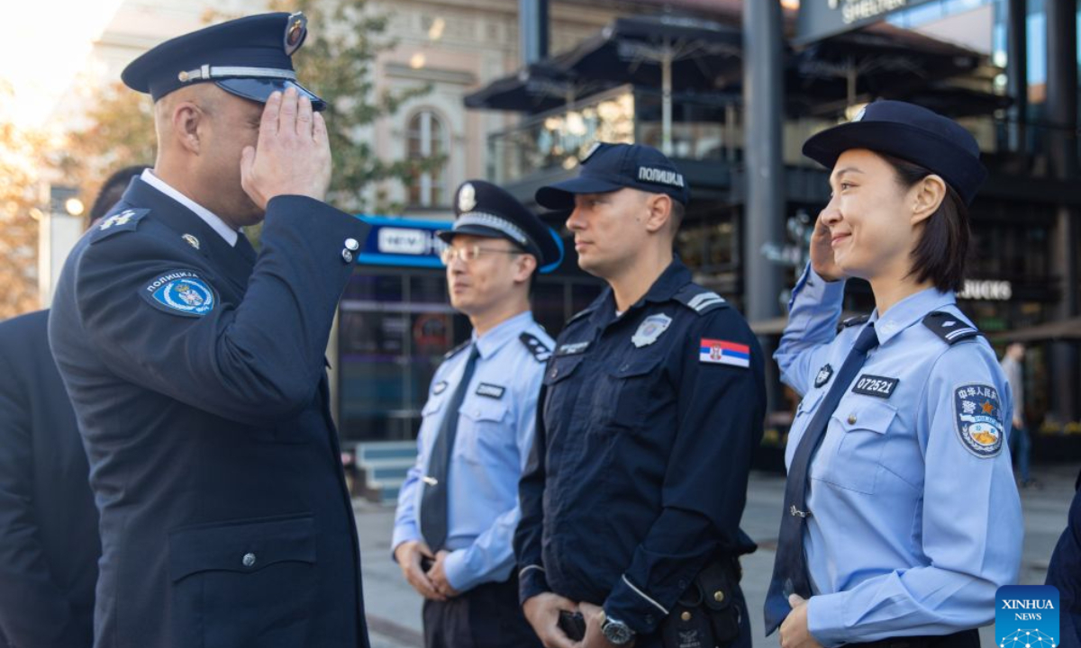 Vladimir Stojanov (L), deputy chief of the Uniformed Police Department of Serbia's Police Directorate, and a Chinese police officer salute each other during the launch ceremony of a joint patrol program in Belgrade, Serbia, Sept. 23, 2026. Chinese and Serbian police officers launched a three-week joint patrol program in downtown Belgrade on Wednesday, aiming at assisting Chinese tourists and residents and strengthening bilateral law enforcement cooperation. (Photo by Wang Wei/Xinhua)