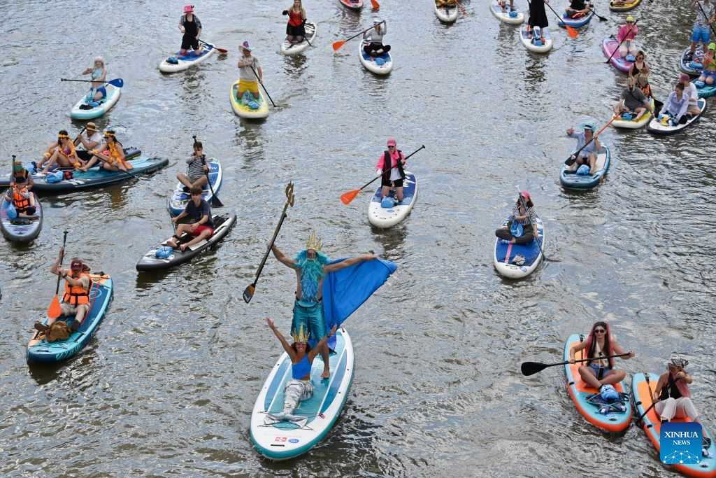 People take part in the annual Yauzafest paddleboarding festival in Moscow, Russia, on Aug. 9, 2026. (Photo by Alexander Zemlianichenko Jr/Xinhua)