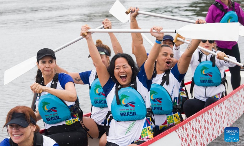 Rowers compete in a dragon boat racing during a cultural event marking the Dragon Boat Festival at Lagoa Rodrigo de Freitas in Rio de Janeiro, Brazil, June 21, 2026. (Photo by Daniel Ramalho/Xinhua)