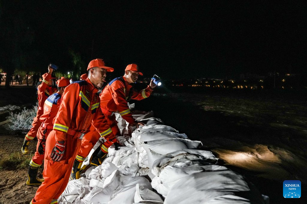 Rescuers monitor water conditions along the Danghe River in Dunhuang, northwest China's Gansu Province, July 29, 2026. The water level of the Danghe River, which runs through Dunhuang City in northwest China's Gansu Province, rose rapidly following days of heavy rainfall and increased inflows from upstream. Local personnel in Dunhuang quickly mobilized for flood control and relief operations. (Xinhua/Lang Bingbing)