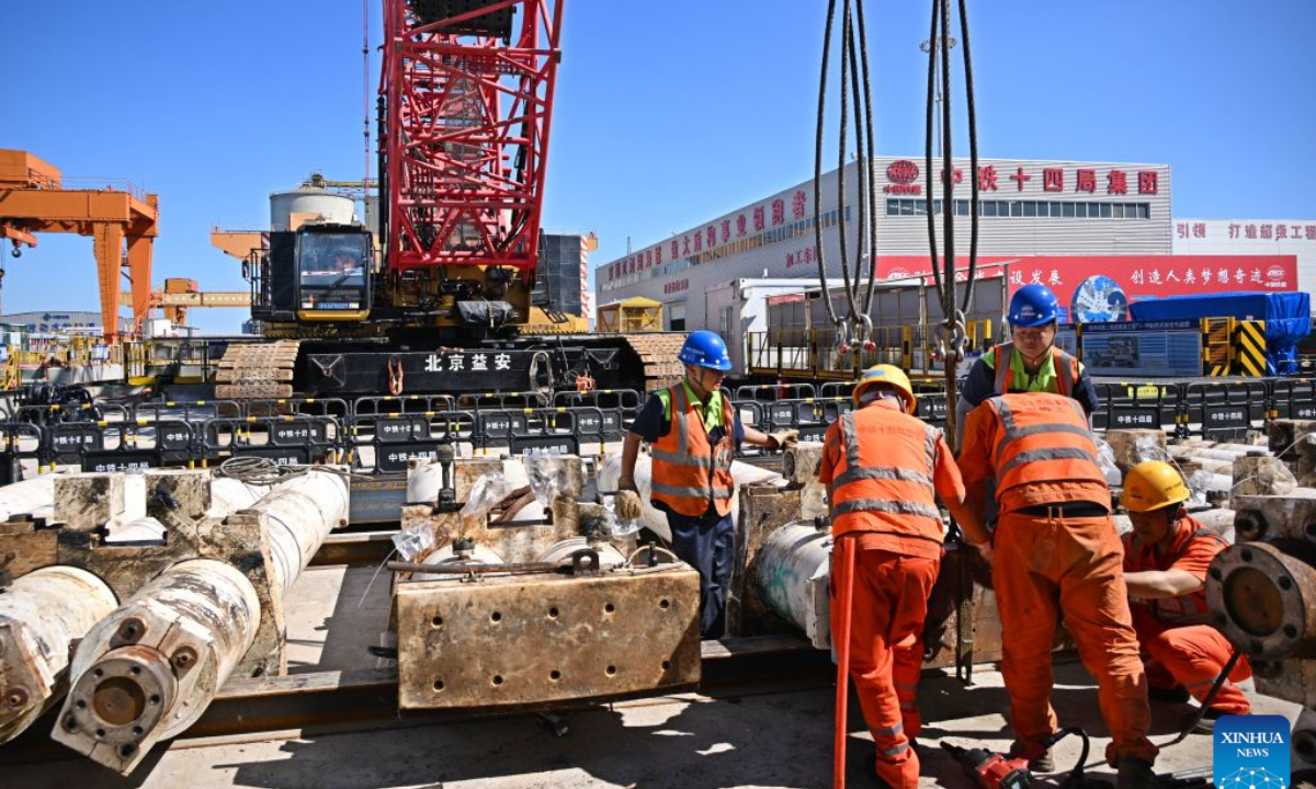 Constructors work at the construction site of Qingdao Jiaozhou Bay Second Tunnel in Qingdao, east China's Shandong Province, Oct. 2, 2026. China's longest undersea highway tunnel completed all shield-driven excavation work on Friday as a shield machine reached its designated position at a depth of 105 meters beneath the sea surface in Jiaozhou Bay, eastern China's Shandong Province, according to China Railway Construction Corporation Limited.
The Qingdao Jiaozhou Bay Second Tunnel will connect Qingdao's main urban area with the Qingdao West Coast New Area. The latter is a national-level new area. The 17.48-km project includes a 14.37-km main tunnel section, featuring two main tunnels and a middle service tunnel, with three lanes in each direction and a design speed of 80 km per hour. (Xinhua/Li Ziheng)