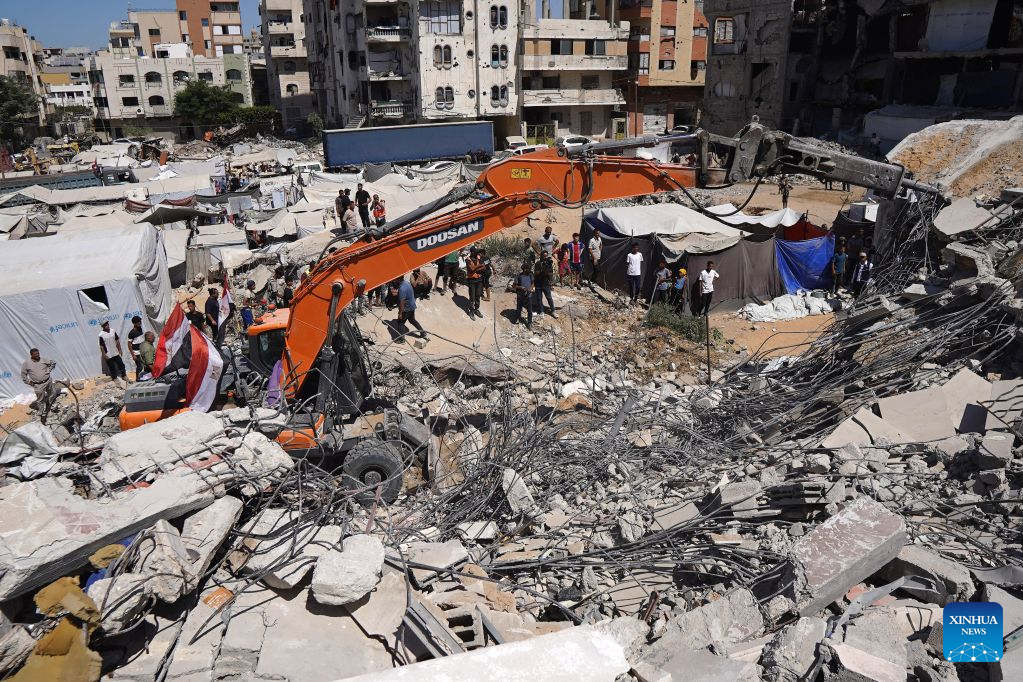 Palestinian civil defense crews search for bodies and survivors in the rubble of a collapsed building that housed displaced Palestinians in Gaza City, Sept. 16, 2026. The death toll from the collapse of a residential building in western Gaza City rose to 21, including 11 children and six women, with more than 25 injured, local officials and residents said Wednesday. (Photo by Rizek Abdeljawad/Xinhua)