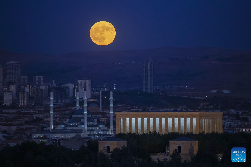 A full moon rises behind Anitkabir, the mausoleum of Turkish Republic's founder Mustafa Kemal Ataturk and Kocatepe Mosque in Ankara, Türkiye, on July 29, 2026. (Mustafa Kaya/Handout via Xinhua)