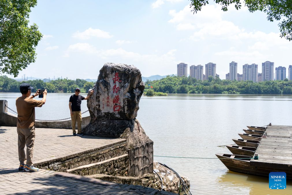 A tourist poses for a photo at a ferry where the Central Red Army left for the Long March in Yudu County, east China's Jiangxi Province, Sept. 8, 2026. This year marks the 90th anniversary of the victory of the Long March by the Red Army under the leadership of the Communist Party of China (CPC). As the starting point of the Long March by the Central Red Army, Yudu County has leveraged its abundant red-themed tourism resources to diversify tourism experiences, promoting both the inheritance of the Long March spirit and the development of local tourism. (Xinhua/Cao Mengyao)