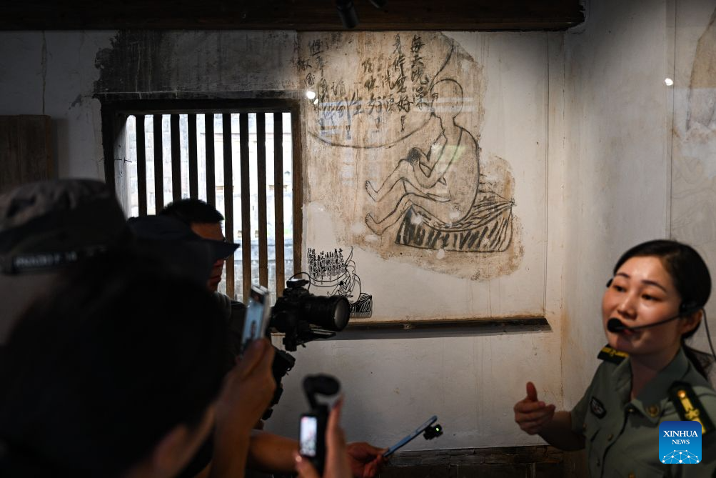 A docent introduces health education paintings on the wall at a former Red Army hospital site in Chentang Village of Shibi Town in Ninghua County, southeast China's Fujian Province, Sept. 9, 2026. This year marks the 90th anniversary of the victory of the Long March by the Red Army under the leadership of the Communist Party of China (CPC). The former Red Army hospital site is located in Chentang Village, Ninghua County, one of the starting points of the Long March by the Central Red Army. (Xinhua/Zheng Huansong)