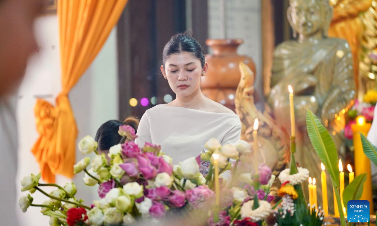 A woman prepares offerings during the Pchum Ben festival in Phnom Penh, Cambodia, Oct. 10, 2026. Cambodia on Saturday started to observe its traditional three-day Pchum Ben holiday, also known as Ancestor's Day, running from Oct. 10 to 12. (Photo by Sovannara/Xinhua)
