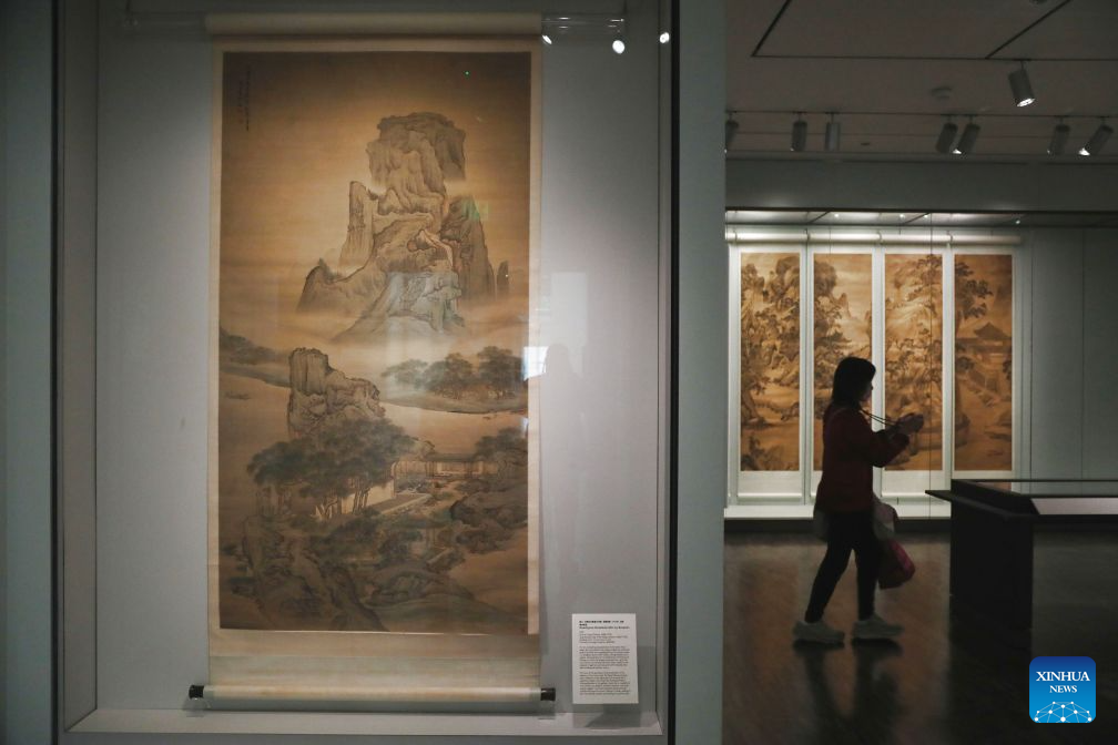 A visitor takes photos of an exhibit at an exhibition named The Mountains of the Mind: A Chinese Landscape Journey at the Asian Art Museum in San Francisco, the United States, Sept. 19, 2026. The exhibition, featuring over 20 paintings, runs from December 13, 2025 to October 26, 2026. (Photo by Liu Yilin/Xinhua)
