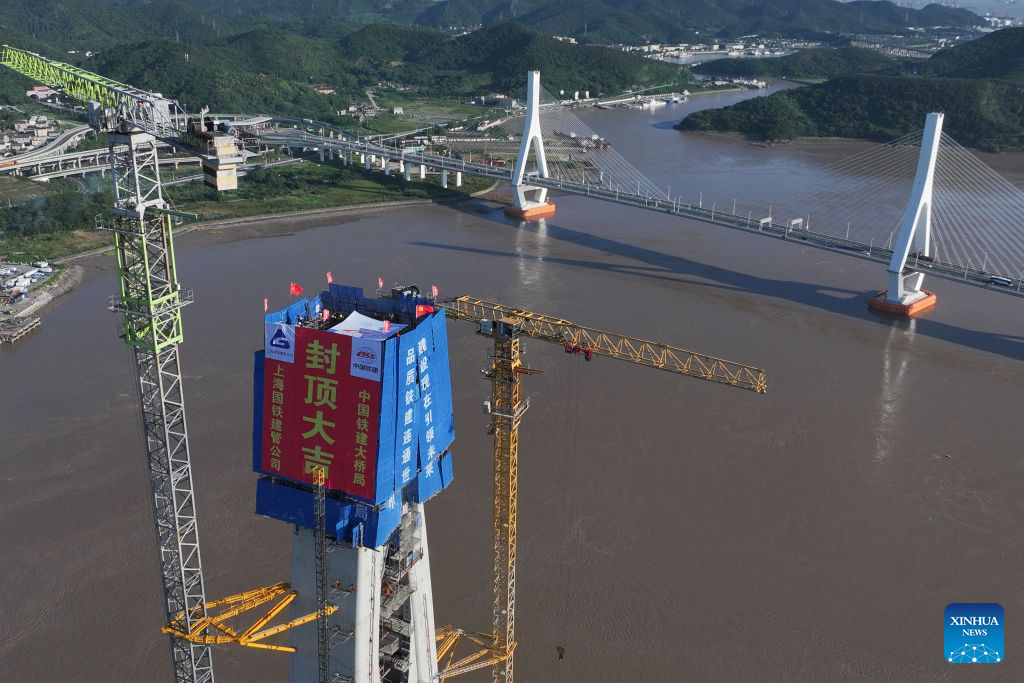 An aerial drone photo taken on Sept. 12, 2026 shows the construction site of the No. 20 main tower of Fuchimen road-rail bridge along Ningbo-Zhoushan Railway in Zhoushan, east China's Zhejiang Province. The main tower, constructed by the China Railway Major Bridge Engineering Group Co., Ltd., was successfully topped out on Sunday, marking the completion of the construction of all six main towers of the three cross-sea bridges of the Ningbo-Zhoushan Railway.

The main line of the Ningbo-Zhoushan Railway is 76.4 kilometers long, starting from Ningbo East Railway Station in the west and ending at Zhoushan Island in the east, with a designed speed of 250 kilometers per hour. (Xinhua/Huang Zongzhi)