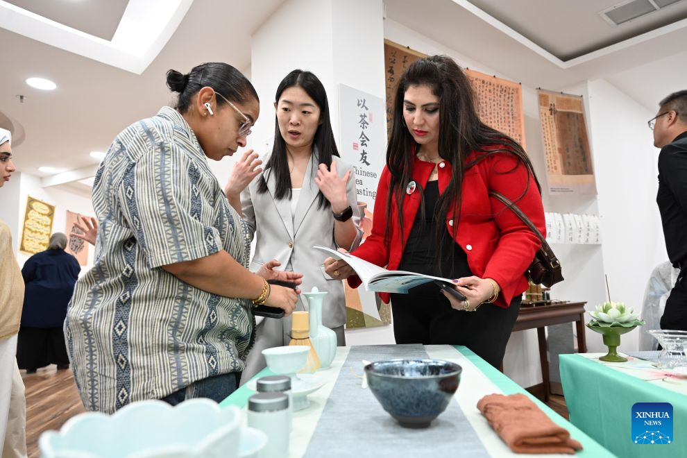 People participate in the Chinese & Kuwaiti Tea Art and Treats Tasting event at the China Cultural Center in Kuwait in Hawalli Governorate, Kuwait, Aug. 23, 2026. (Photo by Asad/Xinhua)