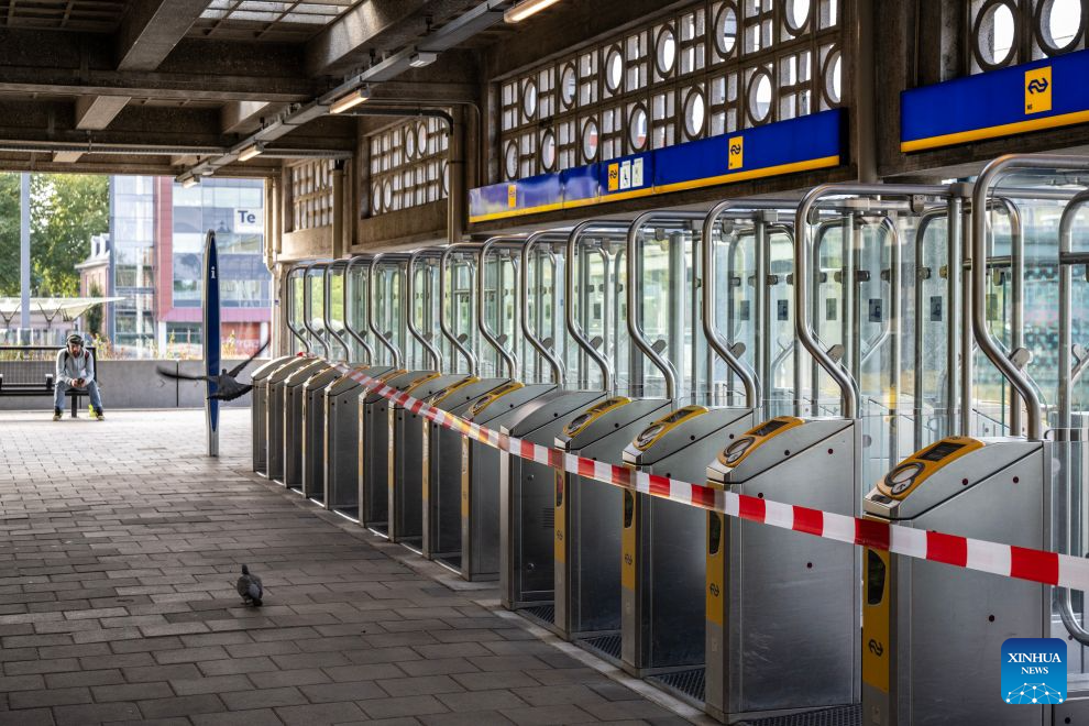 A man sits outside the closed entrance of Enschede train station in Enschede, the Netherlands, on Sept. 9, 2026. Dutch trade unions announced a nationwide 24-hour public transport strike for Sept. 9, in protest against Dutch government's planned social security cuts. (Photo by Eric Brinkhorst/Xinhua)