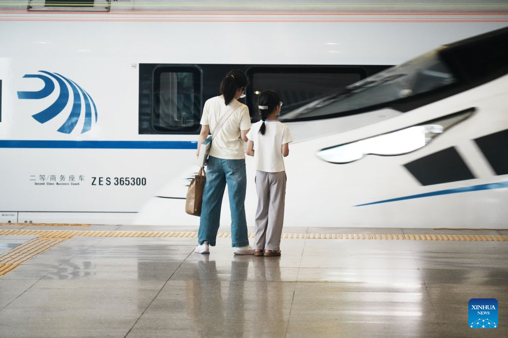 Passengers wait to board a train at the platform of Hangzhou East Railway Station in Hangzhou, east China's Zhejiang Province, Aug. 31, 2026. The 62-day summer travel rush officially concluded on Monday. (Photo by Long Wei/Xinhua)