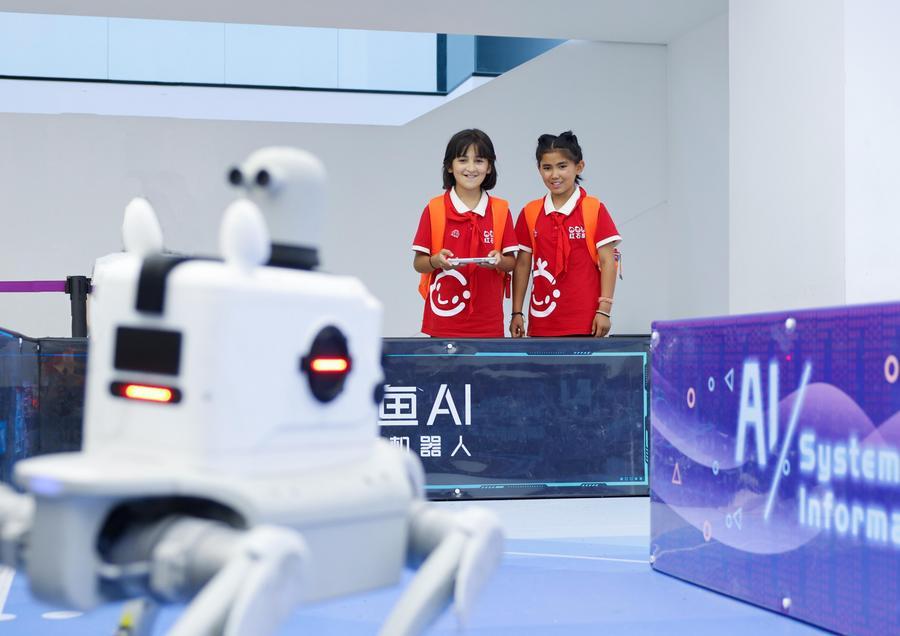 Students attending a summer camp control a robot at an AI robot technology experience center in Shanghai, east China, July 19, 2026. (Photo by Zhang Xu/Xinhua)