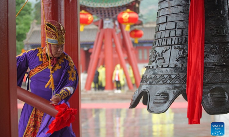 A staff member rings a bell during a ceremony worshiping Fuxi, a mythical ancestor of the Chinese nation, in Tianshui, northwest China's Gansu Province, June 21, 2026. Tianshui is known as the birthplace of the mythical figure, who is worshiped for his contribution to teaching people about fishing, hunting and animal husbandry. According to historical records, the annual commemoration of Fuxi has a history of more than 2,000 years. It was listed as a form of national intangible cultural heritage in 2006. (Photo by Liu Keying/Xinhua)