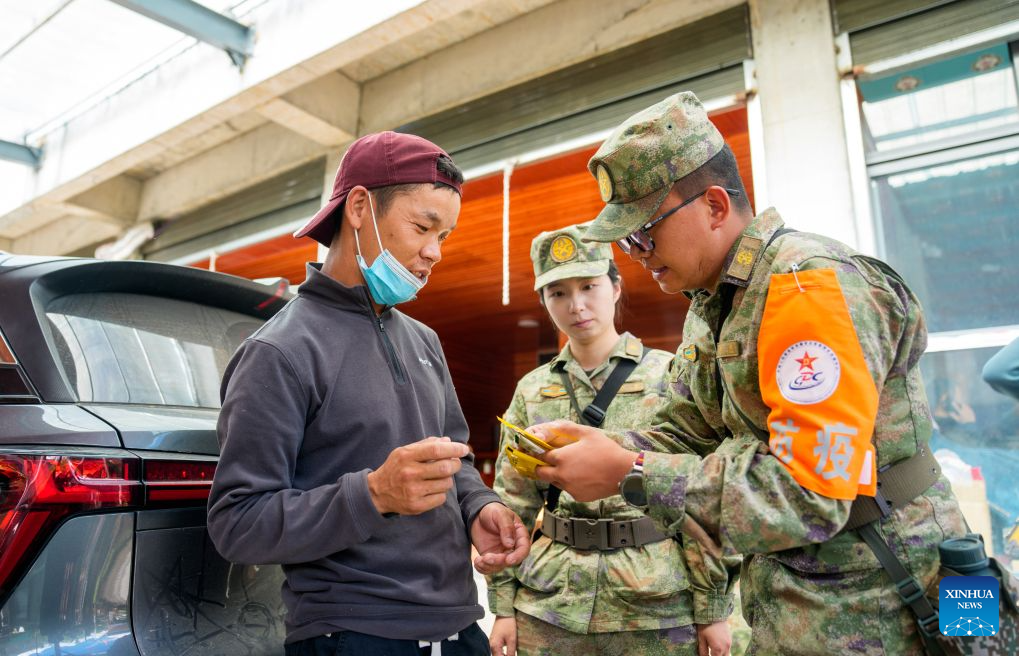 A military health worker hands over medicines to a local at a village in Gyirong Town, southwest China's Xizang Autonomous Region, Sept. 1, 2026. Health workers from the Xizang military authority carried out on-site medical rounds and disinfection on Tuesday to ensure fundamental medical needs of the rescuers and the locals. (Xinhua/Tenzin Nyida)
