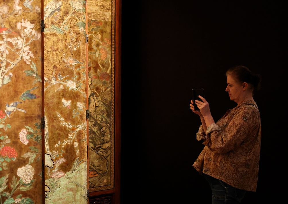 A visitor takes photos of an exhibit on display at Maison Guimet in Paris, France, Sept. 15, 2026. Maison Guimet is housed in the Hotel d'Heidelbach, a private mansion built in 1913. The mansion became part of the Guimet National Museum of Asian Arts in 1991 and reopened to the public as Maison Guimet in May, 2026 following renovation. (Xinhua/Wu Huiwo)
