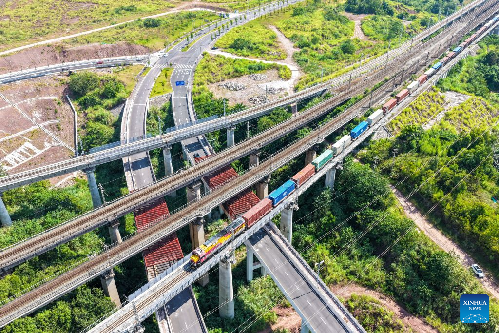 An aerial drone photo taken on July 30, 2026 shows a freight train of the New International Land-Sea Trade Corridor departing from Yuzui Station in Chongqing, southwest China. A total of 961 rail freight train trips were operated from Chongqing via the New International Land-Sea Trade Corridor in the first half of the year, up 25.6 percent year on year, according to the logistics division of China Railway Chengdu Group Co., Ltd.
Chongqing's imports and exports via the corridor amounted to 28.71 billion yuan (about 4.25 billion U.S. dollars) during the same period, rising 13.7 percent year on year, according to data from Chongqing Customs. (Xinhua/Tang Yi)