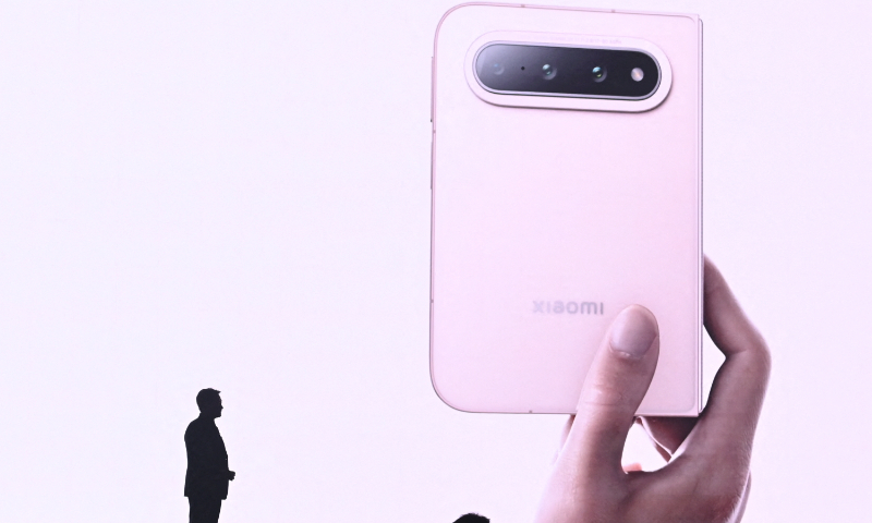 Lei Jun, founder and CEO of the Chinese tech company Xiaomi, unveils the new Xiaomi 18 Fold foldable smartphone at a launch event in Beijing, on September 7, 2026. Photo: VCG