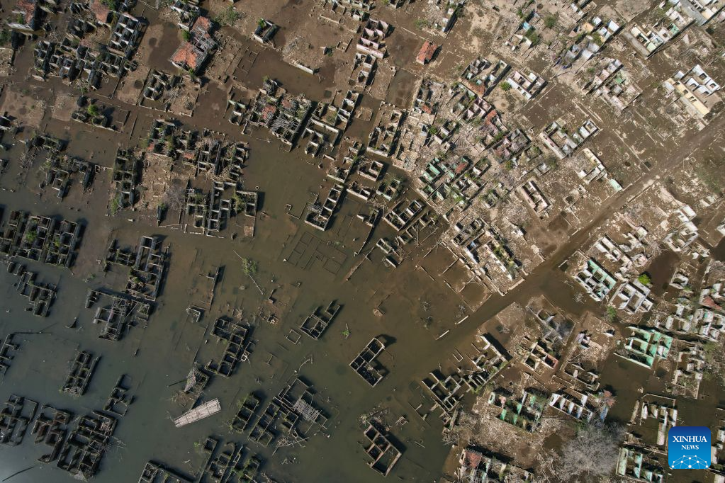 An aerial drone photo taken on July 28, 2026 shows remains of houses re-emerging as the reservoir's water level drops in Lebak regency, Banten province, Indonesia. Due to the impact of El Nino, the dry season in Indonesia has been more intense and prolonged this year, with heightened risks of wildfires and droughts. (Xinhua/Veri Sanovri)