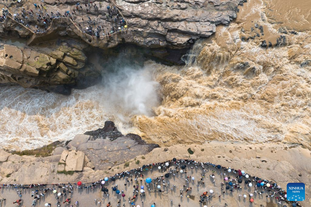 An aerial drone photo taken on Aug. 10, 2026 shows a view of the Yellow River's Hukou Waterfall on the border of north China's Shanxi Province and northwest China's Shaanxi Province. With the completion and operation of transport infrastructure, such as the Yanhuang Highway in northwest China's Shaanxi Province and the Yellow River No.1 Tourist Highway in north China's Shanxi Province, tour along the Yellow River has become a popular choice for many travelers in summer. (Xinhua/Shao Rui)