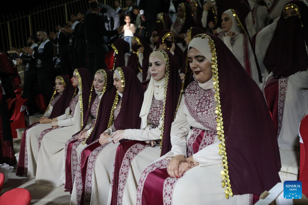 Brides attend a mass wedding ceremony in Dura near the West Bank city of Hebron, on Sept. 26, 2026. The mass wedding ceremony brought together 88 Palestinian grooms and brides, with thousands of local residents attending the event. (Photo by Mamoun Wazwaz/Xinhua)