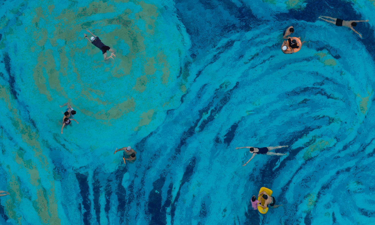 People swim in a special pool in Chengdu, Southwest China's Sichuan Province, on June 22, 2026. The pool features a mosaic recreation of Vincent van Gogh's The Starry Night, with swirling blue-toned patterns resembling a flowing oil painting. Photo: VCG