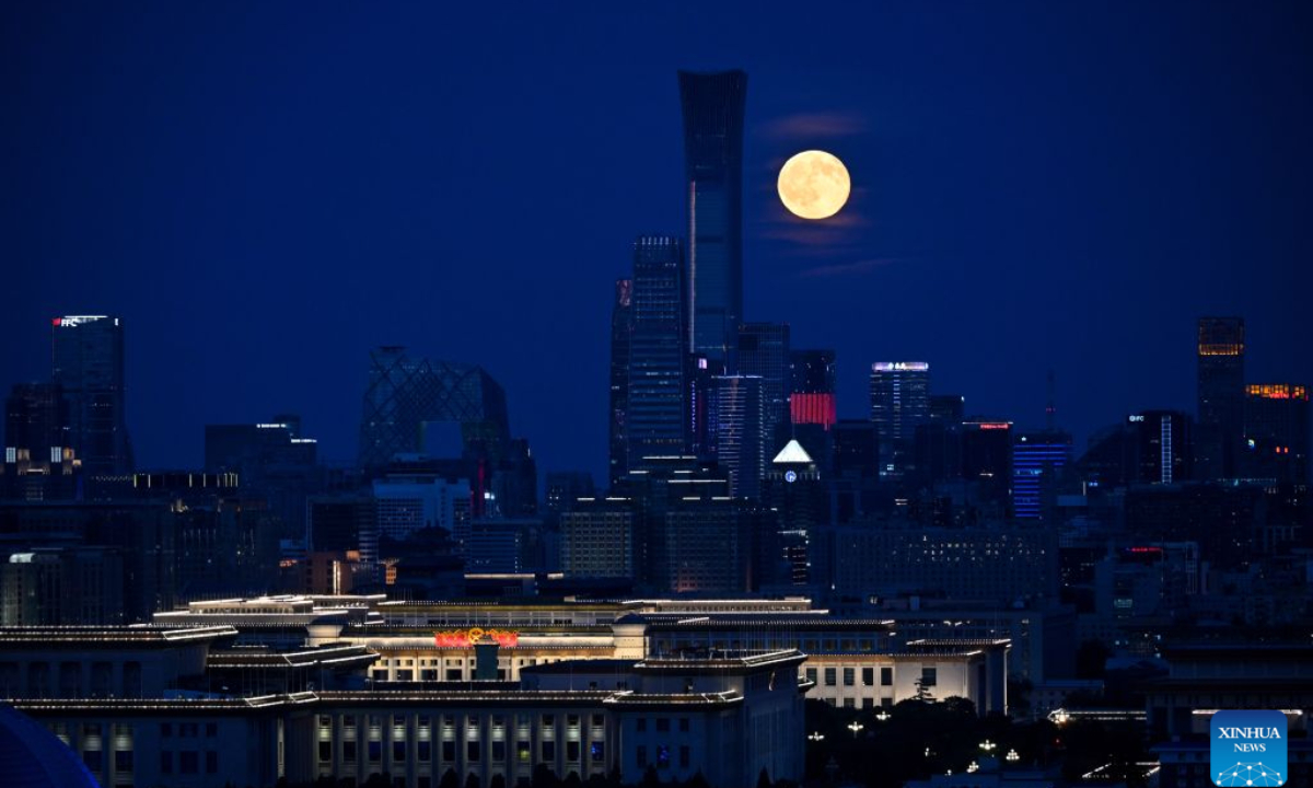 The moon rises over the skyline in Beijing, capital of China, Sept. 27, 2026. Sept. 27 marks the last day of the Mid-Autumn Festival holiday. (Xinhua/Liu Jinhai)