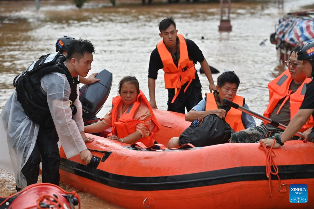 Rescuers transfer stranded residents in Ningming County, south China's Guangxi Zhuang Autonomous Region, Aug. 23, 2026. For days, Ningming County has been battered by typhoon-triggered heavy rainfall. Response forces have pooled their efforts to urgently evacuate stranded residents. (Xinhua/Zhou Hua)