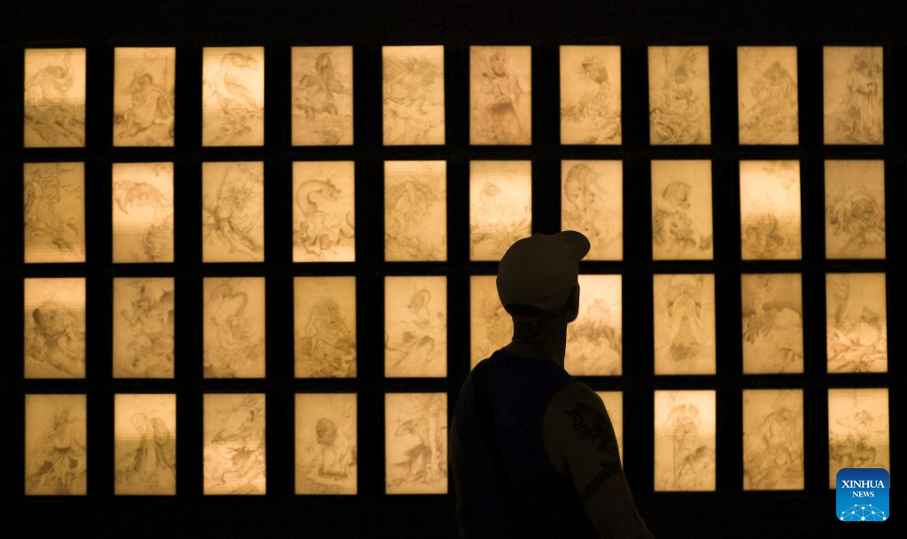 A visitor watches an exhibit themed Portraits at the China pavilion themed Dream Stream of the 61st International Art Exhibition of La Biennale di Venezia in Venice, Italy, Sept. 1, 2026. (Xinhua/Wang Kaiyan)