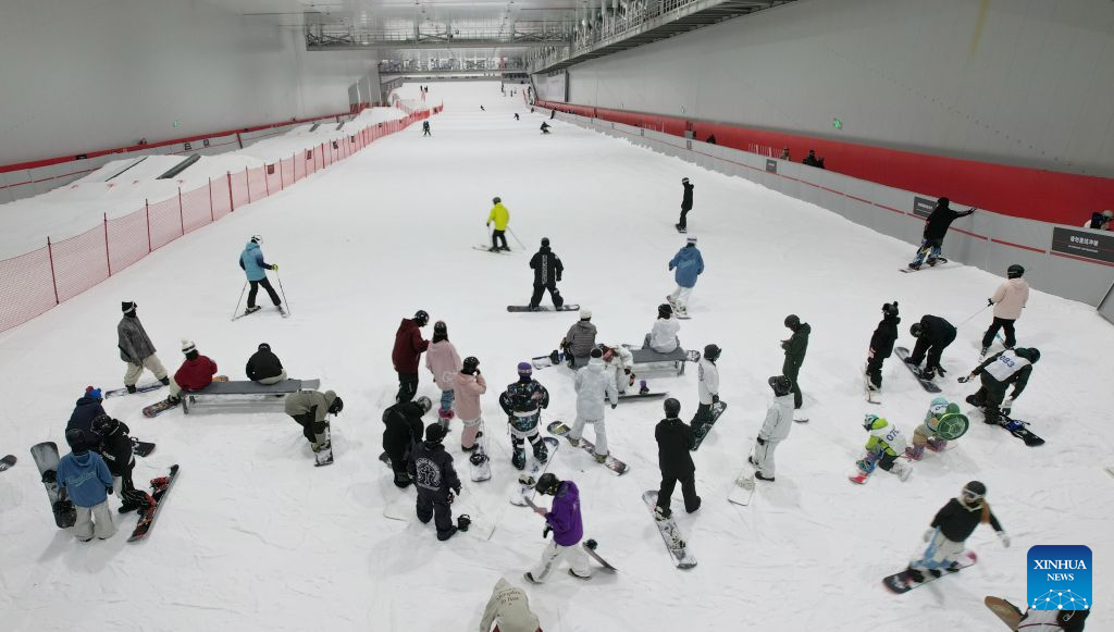 People ski at an indoor ski resort in Shijiazhuang, north China's Hebei Province, July 21, 2026. The city of Shijiazhuang has been focusing on developing its ice-and-snow economy during summers in recent years. A number of indoor ski resorts across the city have rolled out consumption subsidies and hosted professional competitions to develop a heat-relief business model. (Photo by Yan Zhiguo/Xinhua)