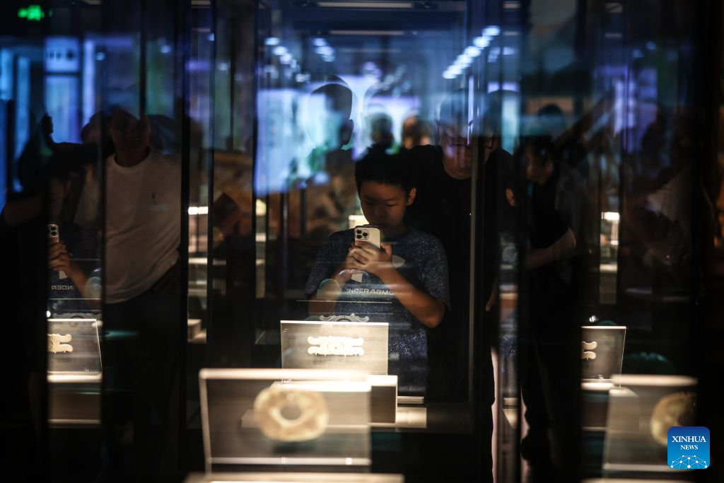 A boy visits the Niuheliang site museum at the Niuheliang national archaeological relic site park in Chaoyang City, northeast China's Liaoning Province, Aug. 4, 2026. The Niuheliang national archaeological relic site park was built on the Niuheliang site, a large-scale prehistoric ritual and burial complex featuring the temple of the goddess, altars and stone tombs. Dating back more than 5,000 years, the site unearthed stone tools, pottery and jade artifacts with dragon, phoenix and human motifs, reflecting the rituals and beliefs of the Hongshan culture. (Xinhua/Pan Yulong)