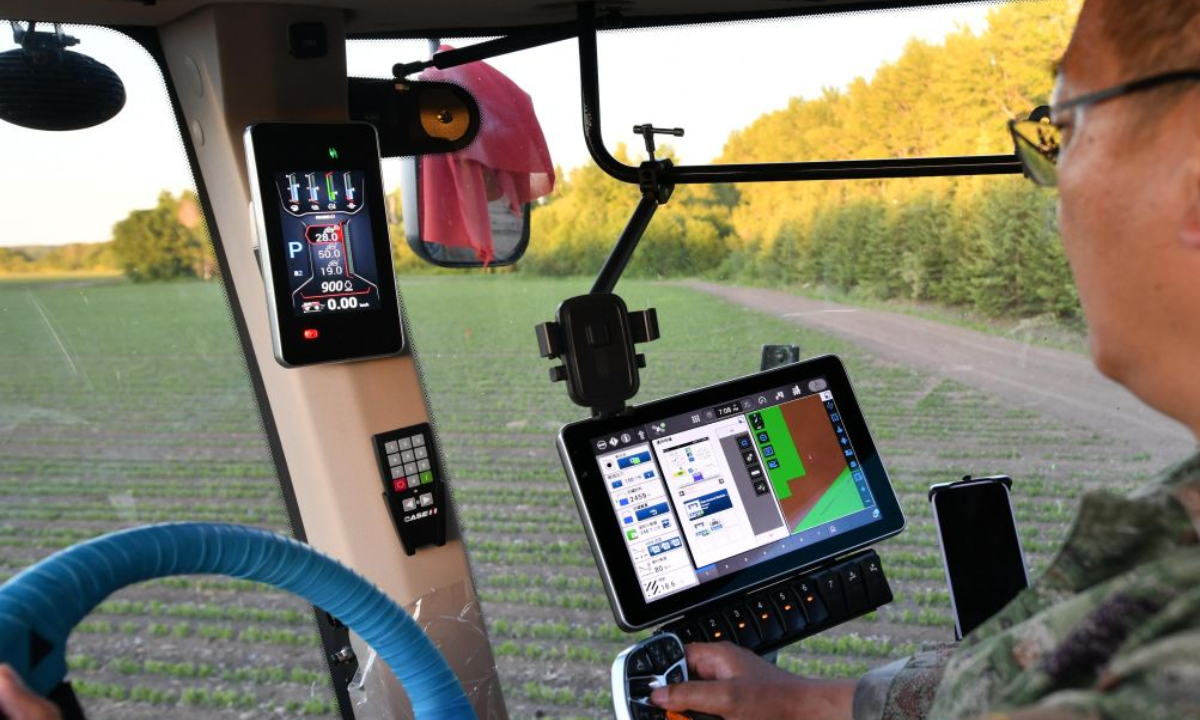 A farmer operates an agricultural machine equipped with BeiDou Navigation Satellite System (BDS) in a soybean field in northeast China's Heilongjiang Province, June 13, 2026. (Photo by Qian Boyu/Xinhua)