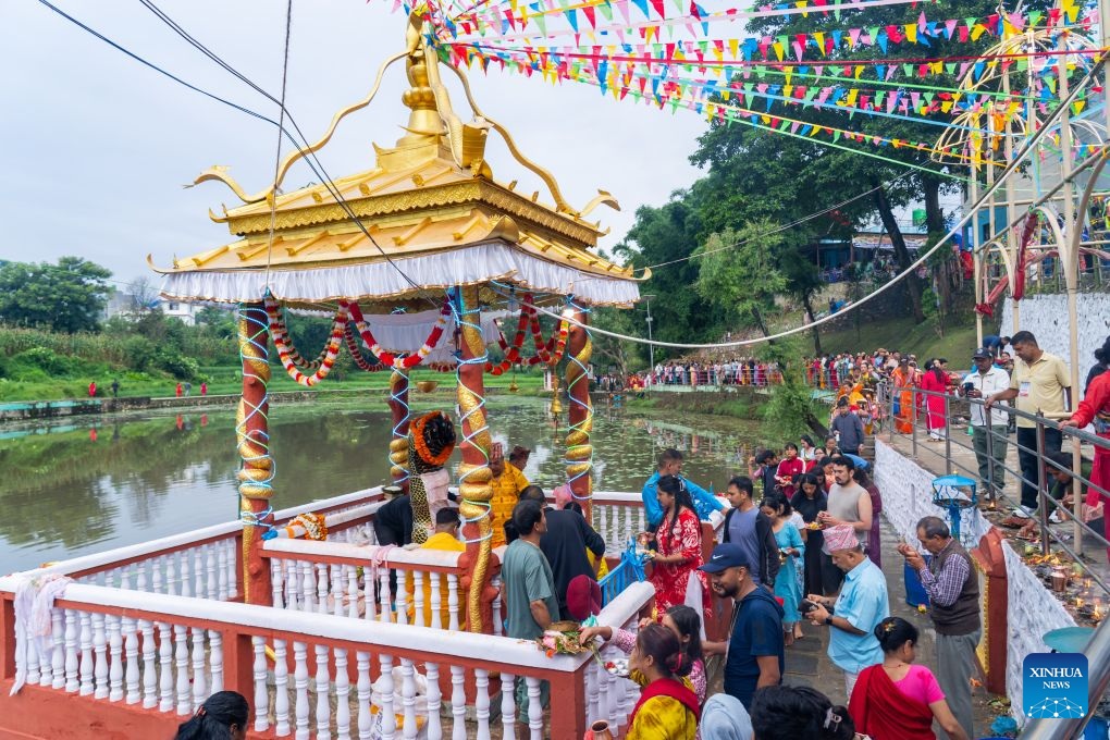 People attend the celebration of Nag Panchami, a Hindu festival dedicated to the worship of snakes, on Nagdaha Lake in Lalitpur, Nepal, Aug. 17, 2026. (Photo by Hari Maharjan/Xinhua)