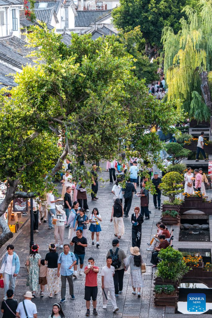 Tourists visit the ancient town of Dali in Dali, southwest China's Yunnan Province, Aug. 22, 2026. The ancient town of Dali has entered its peak tourism season during the summer holiday. According to the ancient town protection and management department, the ancient town recorded over 22 million tourist trips in the first seven months of 2026. (Xinhua/Hu Chao)