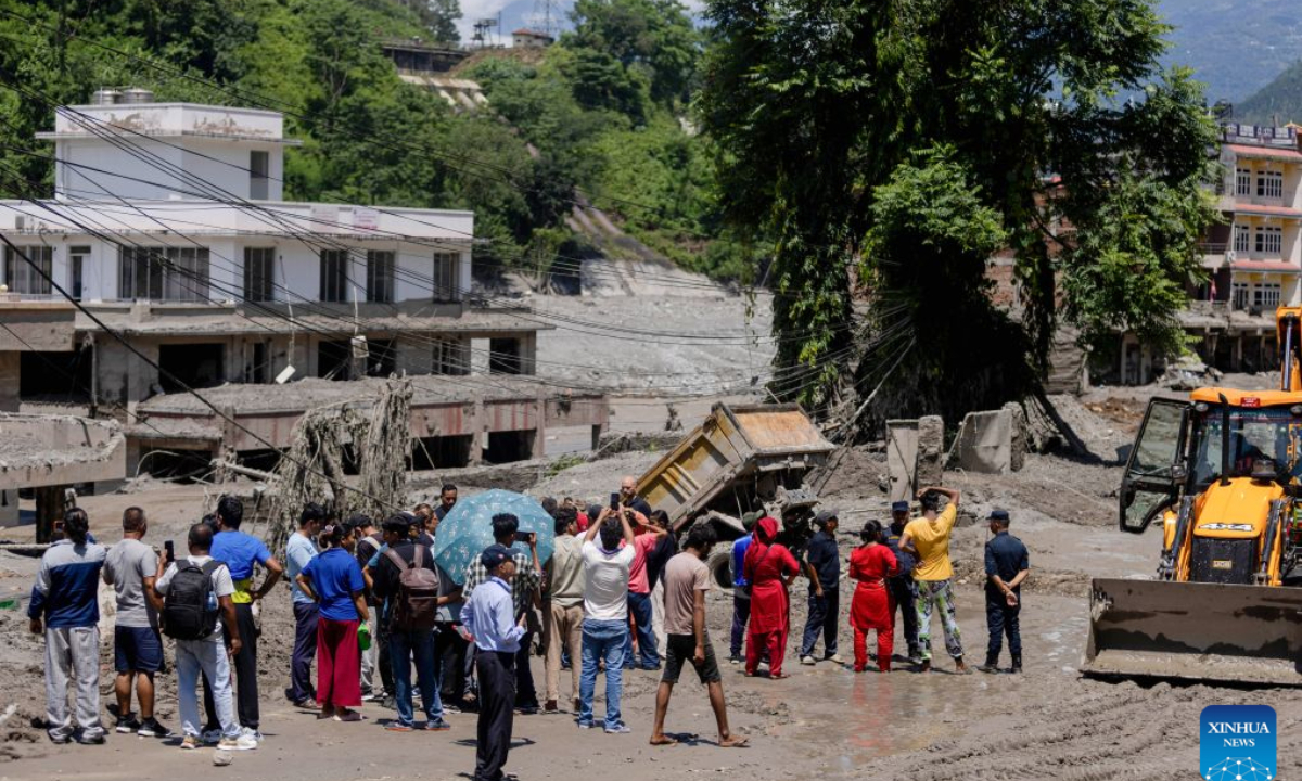 People gather as rescue and search operations are underway after a massive flash flood in Nuwakot, Nepal, on Aug. 27, 2026. Nepal's National Disaster Risk Reduction Management Authority said that as many as 359 bodies had been recovered from flood-hit areas by Thursday evening, with 910 people still missing. (Photo by Sulav Shrestha/Xinhua)