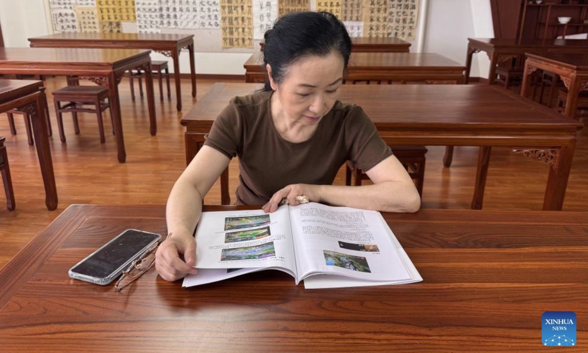 Gao Liying reads an esports manual she compiled in Hangzhou, east China's Zhejiang Province, June 24, 2026. (Xinhua/Zheng Keyi)