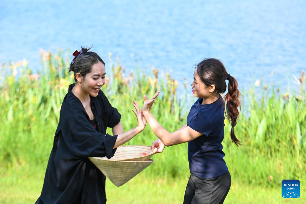 Vu Minh Anh (L) practices dancing by a lake with a student in Nanning, south China's Guangxi Zhuang Autonomous Region, Sept. 17, 2026.
For 30-year-old Vietnamese choreographer Vu Minh Anh, China is an important country in her dance career. Her connection with Chinese dance began in childhood. At 11, she came to Guangxi through a China-ASEAN arts cooperation program to study dance at a school.
After graduating in 2013, Vu returned to Vietnam and worked at a local theater. To pursue advanced professional training, she continued her studies at Guangxi Arts University in 2018, where she completed both her bachelor's and master's programs. She now teaches choreography at the university.
My connection with China grew from Chinese dance shows I watched as a child, Vu said. The refined grace of Chinese dance has always fascinated me.
Vu recalled arriving in China at a young age and feeling daunted by language barriers and unfamiliar daily routines. With help from her teachers and classmates, Vu quickly learned Chinese and adapted to campus life.
Years of working in Vietnam made Vu realize she still needed further artistic enrichment. I chose to return to China, where my dance dream started. This place has always given me warmth and motivation, she shared.
Cultural integration defines Vu's choreographic style. As a teacher and creator, she seamlessly blends traditional Vietnamese aesthetics with Chinese dance. Her innovative works have won multiple awards at home and abroad.
Now settled in China, Vu actively explores new artistic inspirations and regularly visits China's ethnic minority areas to draw creative inspiration from local cultures. (Xinhua/Cao Yiming)