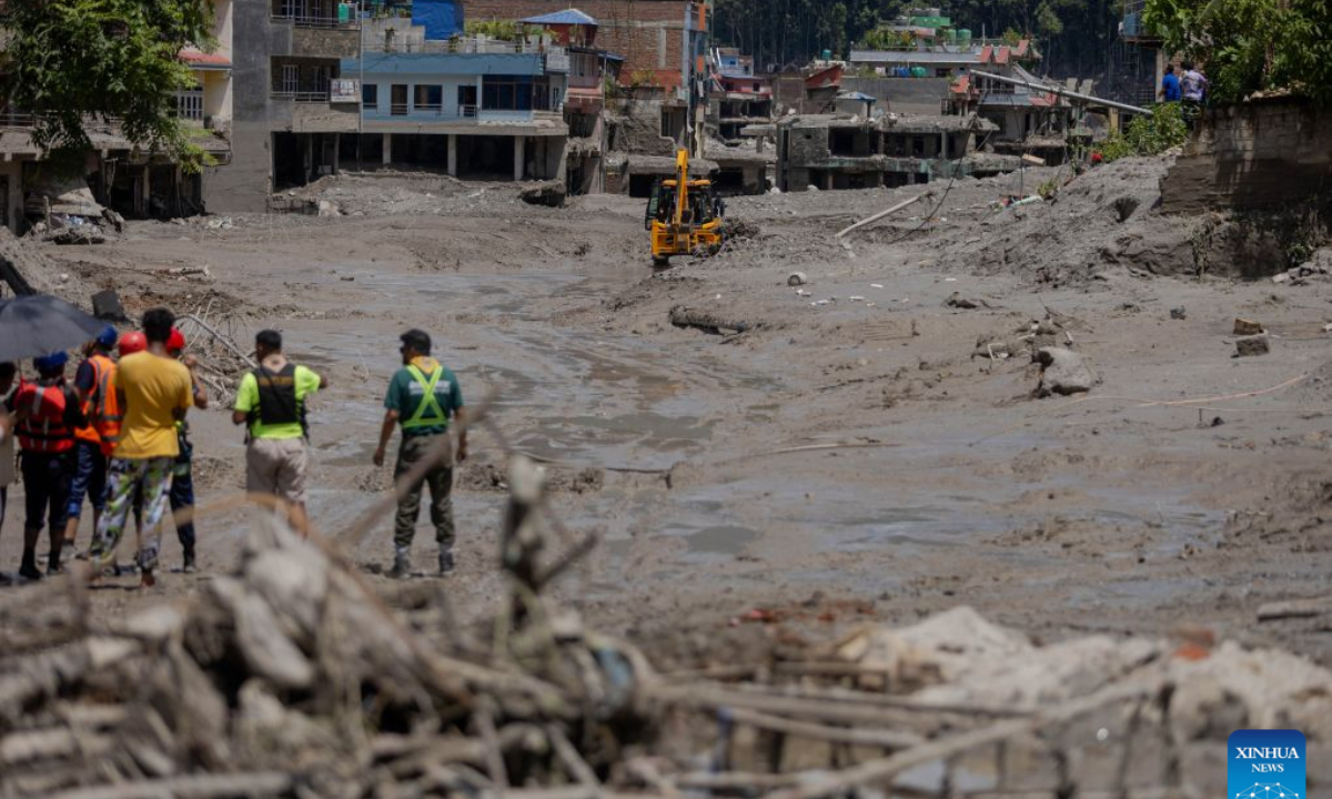 People conduct rescue work after a massive flash flood in Nuwakot, Nepal, on Aug. 27, 2026. Nepal's National Disaster Risk Reduction Management Authority said that as many as 359 bodies had been recovered from flood-hit areas by Thursday evening, with 910 people still missing. (Photo by Sulav Shrestha/Xinhua)