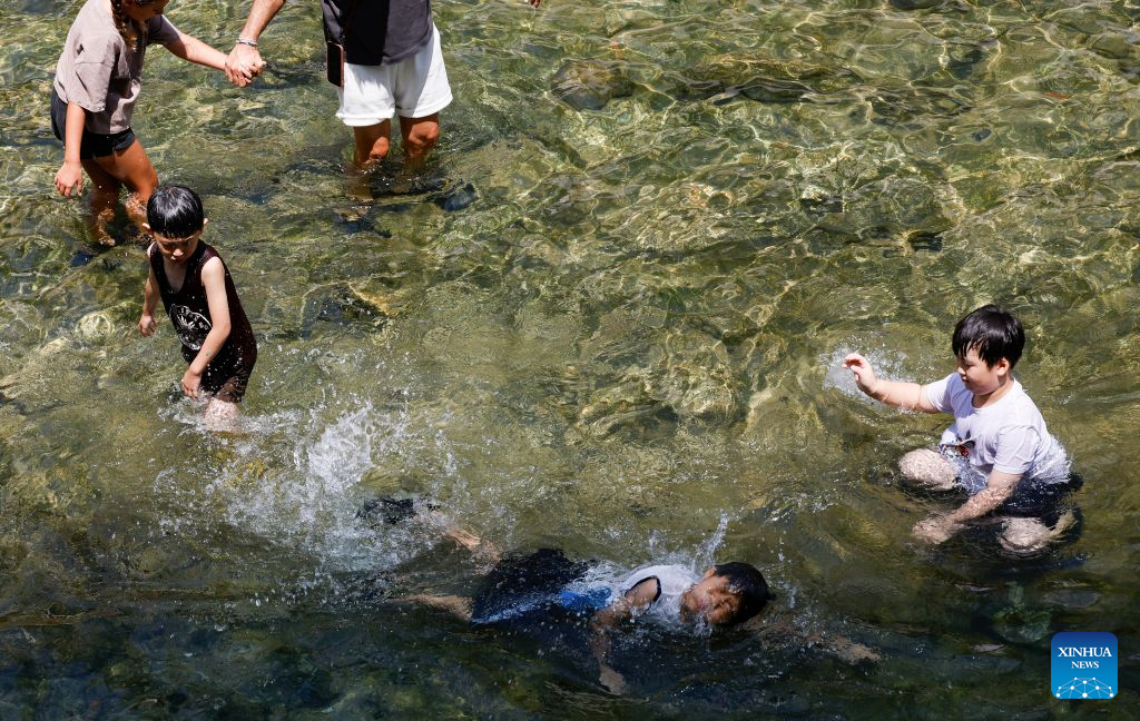 Children play at the Cheonggye stream to cool off amid a heatwave in Seoul, South Korea, Aug. 2, 2026. (Photo by Jun Hyosang/Xinhua)