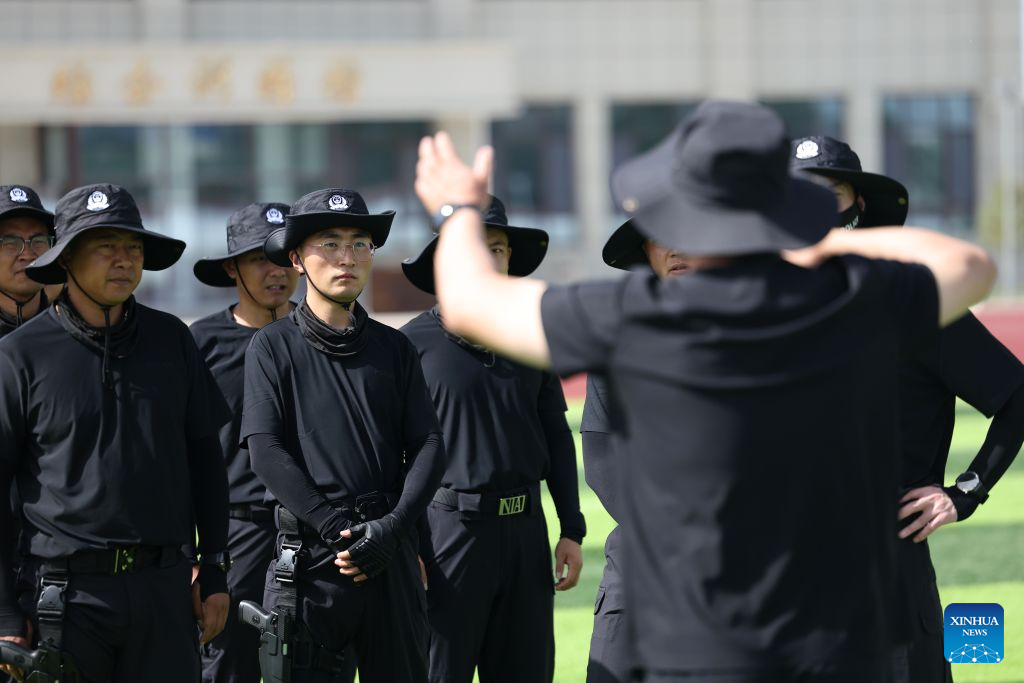 Li Junjie (4th L) takes part in a training session at a training ground of the Gansu General Station of Exit and Entry Frontier Inspection in Lanzhou New Area in Lanzhou, northwest China's Gansu Province, July 20, 2026. (Xinhua/Chen Bin)