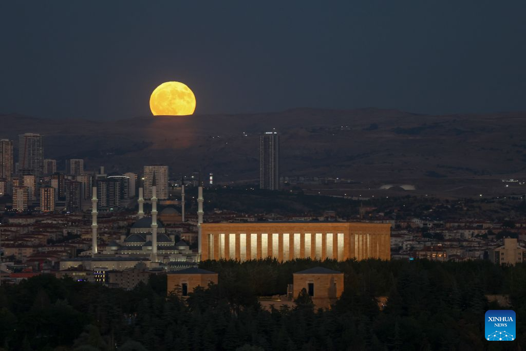 A full moon rises behind Anitkabir, the mausoleum of Turkish Republic's founder Mustafa Kemal Ataturk and Kocatepe Mosque in Ankara, Türkiye, on July 29, 2026. (Mustafa Kaya/Handout via Xinhua)