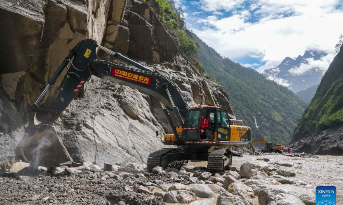 This photo shows a road clearance operation underway in a section of the G216 national highway from Gyirong Town to Gyirong Port in southwest China's Xizang Autonomous Region, on Aug. 30, 2026. China Anneng, a state-owned engineering and rescue enterprise, continued its rescue work on Sunday in an attempt to restore the last few kilometers of damaged section of the G216 national highway leading to Gyirong Port. (Xinhua/Jigme Dorje)