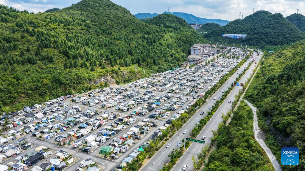 An aerial drone photo shows a RV (recreational vehicles) camping base in Bijie City, southwest China's Guizhou Province, Aug. 11, 2026. In recent years, Bijie City has leveraged its scenic natural environment and pleasant mountain climate to promote the development of RV camping bases and boost summer tourism, drawing RV travelers from across China. (Xinhua/Tao Liang)