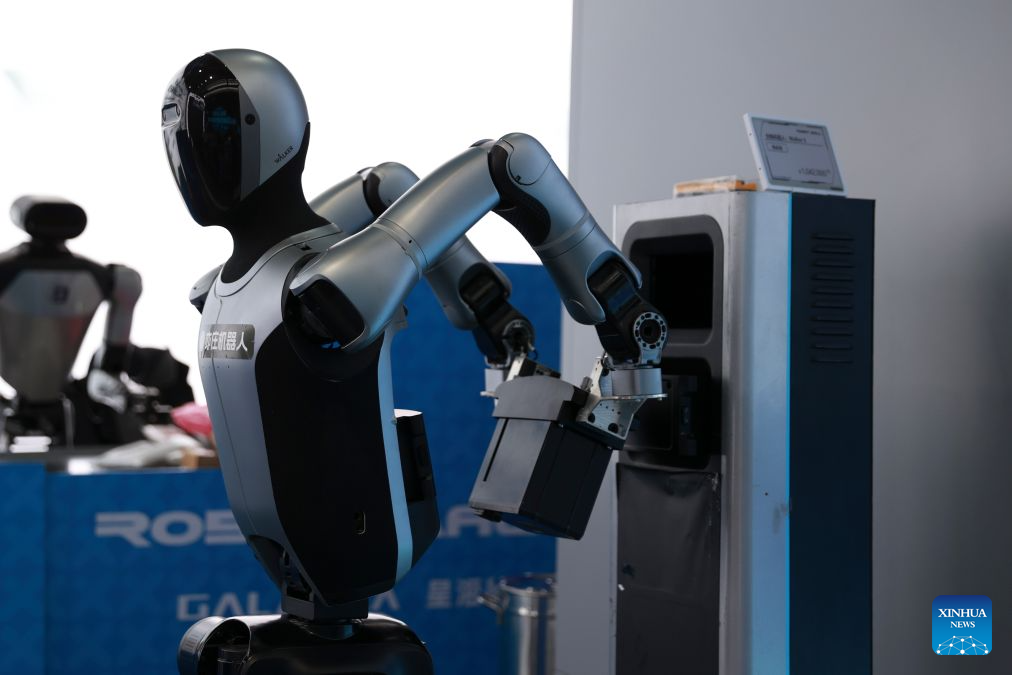 A sorting robot of UBTECH autonomously changes its own battery at Robot Mall, a robot 4S showroom, in Beijing, capital of China, July 1, 2026. The Beijing Economic-Technological Development Area, also known as Beijing E-Town, has managed to cultivate and strengthen a modern system of emerging and forward-looking industries. (Photo by Ma Zihan/Xinhua)