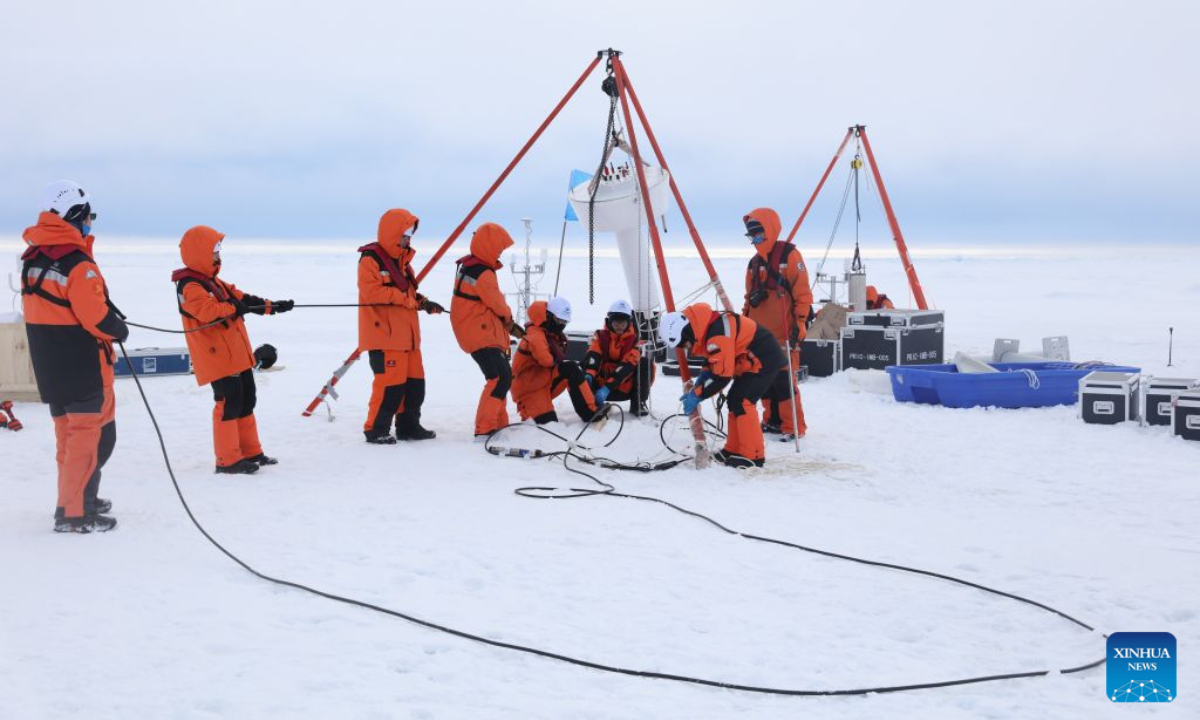Members of China's 16th Arctic Ocean scientific expedition team work on the ice surface of the Arctic Ocean on Aug. 9, 2026. China's research icebreaker Xuelong 2 will carry out more than 20 operations at seven ice stations, including deploying ice-based buoys, collecting ice cores and conducting remote sensing observations of sea ice, to obtain scientific data for research into changes in Arctic sea ice and the evolution of its ecosystems. (Xinhua/Wen Jinghua)