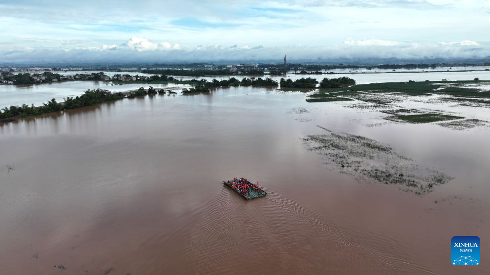 An aerial drone photo taken on Aug. 24, 2026 shows a powered pontoon bridge sailing in the flooded area in Beijiang Township, Ningming County, south China's Guangxi Zhuang Autonomous Region. Rescue forces have been deployed in Ningming County where typhoon-triggered heavy rainfall caused flood. A powered pontoon bridge was deployed for emergency rescue operations on Monday. (Xinhua/Zhou Hua)