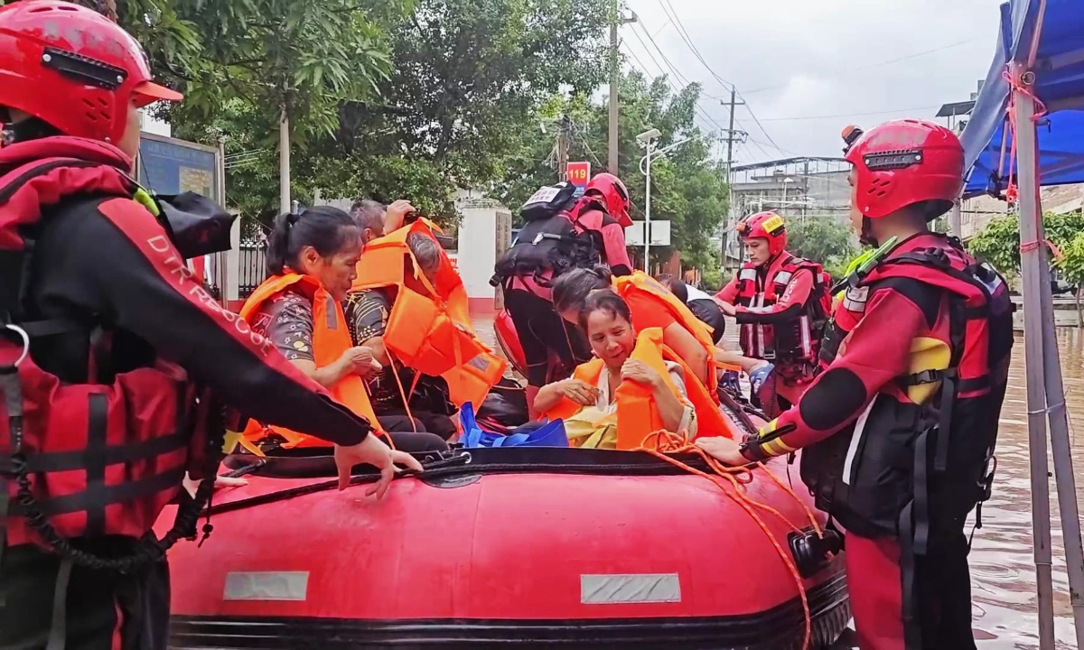 Rescue personnel use boats to evacuate residents to safety after flooding hit a county in Fangchenggang city, South China’s Guangxi Zhuang Autonomous Region, on August 23, 2026, following the impact of a typhoon. Photo: VCG